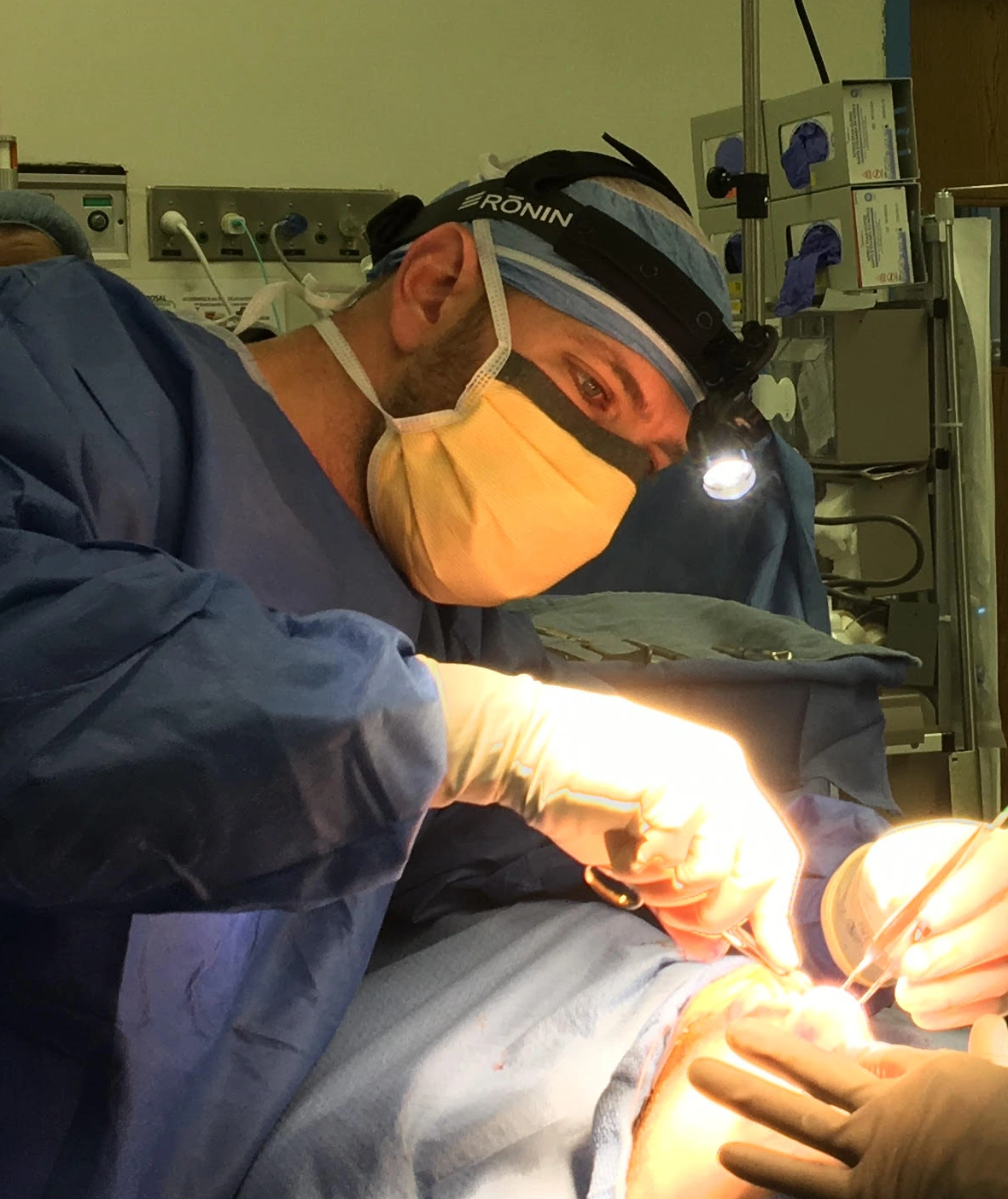 Dr. James Kotick performing surgery with magnification equipment